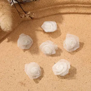 Mini white mesh rose flower heads for DIY crafts, clothing accessories and hair bows.