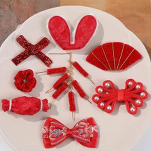 Red festive hair clips detail shot, velvet fabric Chinese style bow and hairpin set accessories.