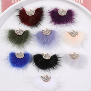 Close-up detail of colorful fuzzy plush rhinestone fan-shaped DIY hair accessory charms.