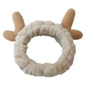 Cute plush headband for face washing with soft antlers design, comfortable daily hair accessory.