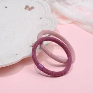 Detailed view of elastic hair ties in soft pink and purple, premium soft knitted design.