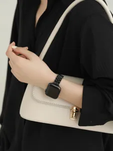 Stainless steel metal link watch band detail view, sleek black three-bead design on wrist.