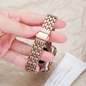 Detailed view of rose gold stainless steel five-bead watch strap folding clasp texture and back.