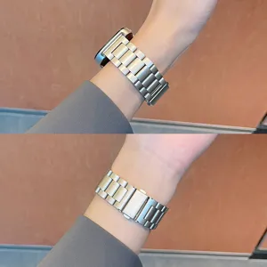 Detail shot of the solid stainless steel metal watch band worn on wrist, showing secure clasp.