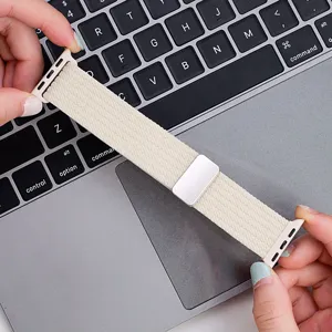 Beige braided nylon watch strap detail, featuring magnetic buckle and metal connectors.
