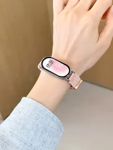 Close-up of pink nylon braided elastic magnetic watch strap worn on wrist detail view.