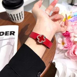 Red leather watch band compatible with Apple Watch, featuring a stylish clover magnetic clasp.