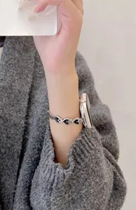Metal heart watch band detail for Apple Watch, stylish silver and black link strap.