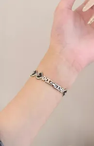 Close-up detail of metal heart link watch band worn on wrist for Apple Watch accessory