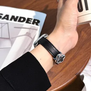 Black leather watch strap compatible with Apple Watch, featuring a chic clover magnetic buckle.