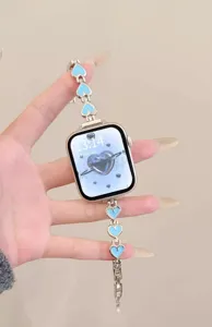 Metal heart watch strap detail, compatible with Apple Watch, elegant silver chain design.