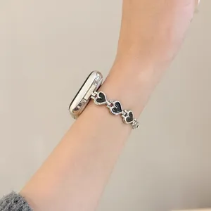 Metal heart watch band compatible with Apple Watch, stylish black and silver link strap design.