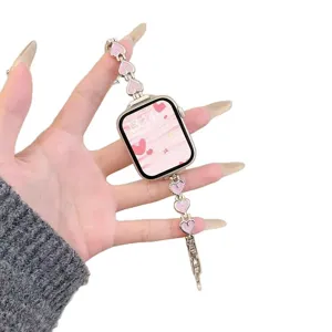 Metal heart watch band compatible with Apple Watch, stylish pink charm strap for women.