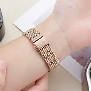 Rose gold stainless steel watch band detail, delicate bead links with folding clasp.