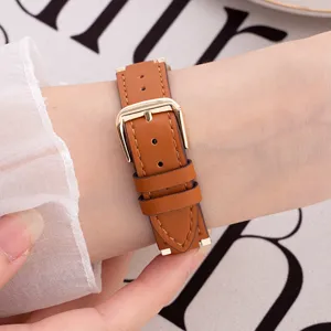 Brown leather watch strap detail view, gold metal pin buckle, compatible with smart watch.