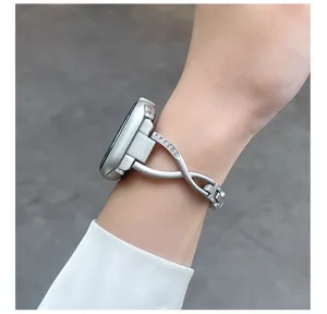 Detailed close-up view of the slim metal cross rhinestone watch band worn on the wrist