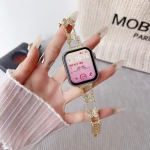 Detail view of gold metal rhinestone butterfly watch strap compatible with smart watches.