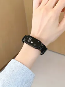 Detailed view of black woven magnetic replacement smart watch band worn on wrist clearly.