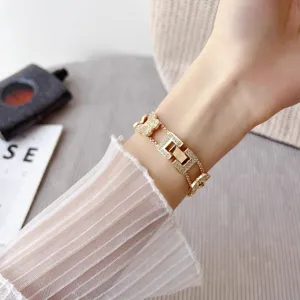 Closeup detail of luxury gold metal rhinestone butterfly watch strap compatible with smart watch.