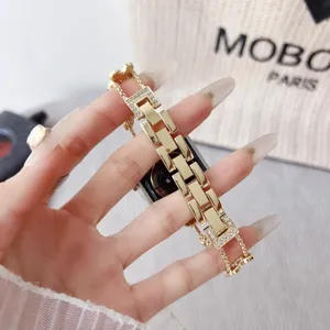 Luxury metal rhinestone watch band compatible with Apple Watch, elegant design details.