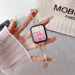 Detailed shot of rose gold metal butterfly rhinestone watch band compatible with Apple Watch.
