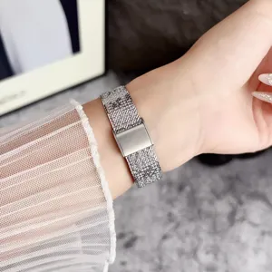 Stainless steel mesh watch strap compatible with smartwatches, thin design with metal buckle.