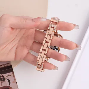 Rose gold metal watch strap compatible with Apple Watch, chic chained rhinestone design for women.