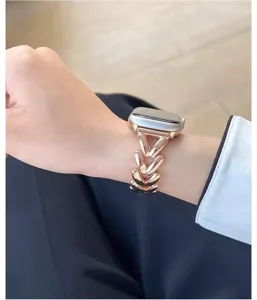 Detailed shot of rose gold metal watch band featuring elegant clover link design for smartwatches.