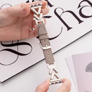 Detailed view of luxury leather and metal V-link watch strap compatible with Apple Watch.