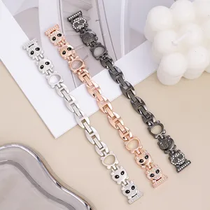 Detailed view of metal watch band compatible with Apple Watch, featuring rhinestone panda design.