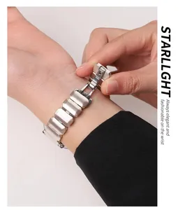 Detailed view of the elegant metal watch strap featuring unique faceted links and a secure clasp.