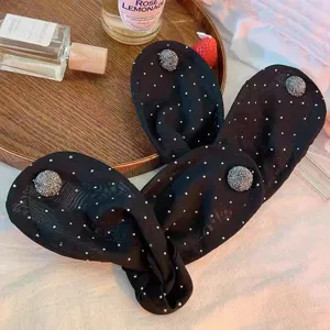 Black mesh hair bun maker twist clip with rhinestone dot accents for elegant styling.