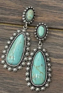 Close-up of vintage antique silver dangle earrings with water-drop turquoise stones