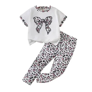 Girls 2-piece outfit featuring white leopard bow T-shirt and matching heart print leggings