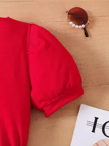 Dettaglio della manica a sbuffo rossa su un top estivo alla moda per bambine