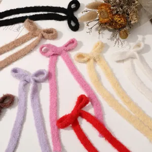 Cozy plush ribbon bow hair clips, soft winter hair accessories in multiple vibrant colors.