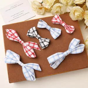 Detailed shot of cute plaid fabric bow appliques, perfect for DIY hair accessories and bags.