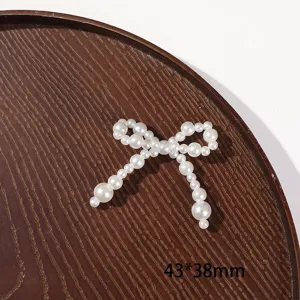 Pearl bow DIY craft accessory detail view showing beaded structure for handmade jewelry.