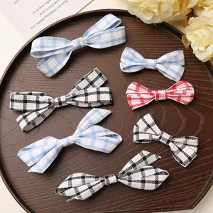 Detailed view of cute plaid fabric bow hair clips in various colors, perfect for DIY accessories.