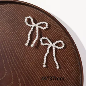Pearl bow DIY craft accessory, handmade beaded hair clip jewelry making material piece.