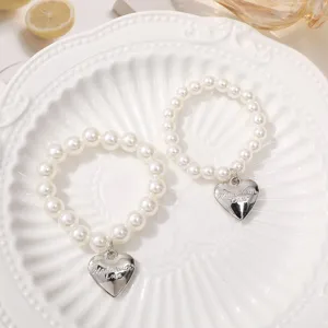 Cute pearl bracelets with silver heart pendants, handmade aesthetic jewelry accessory for women.