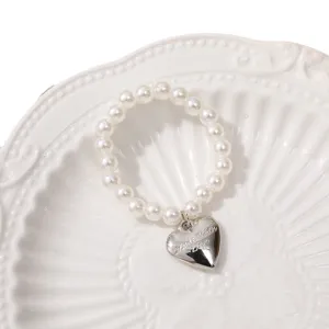 Charming artificial pearl beaded bracelet featuring a silver heart pendant for daily wear.