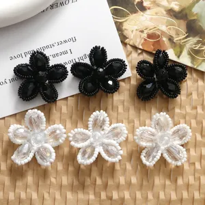 Handcrafted crystal beaded flower DIY jewelry accessories, black and white floral charms detail.