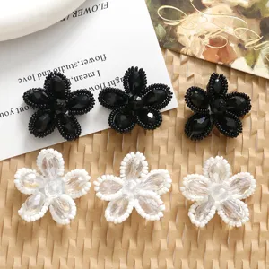 Handmade crystal beaded flower DIY charms, black and white floral accessories for jewelry crafting.