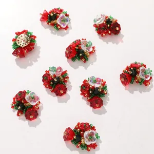 Close-up of red and green beaded flower clusters for Christmas DIY jewelry accessories.