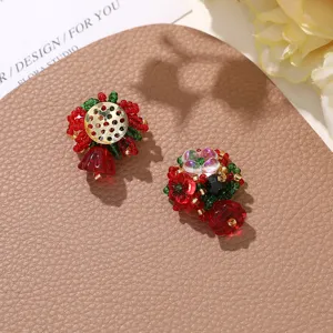 Close-up of handmade Christmas red beaded flower earrings DIY accessories, festive holiday style detail.