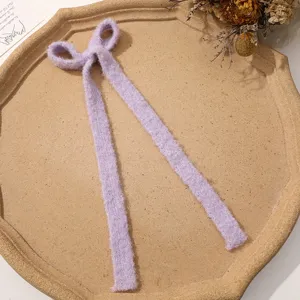 Fuzzy purple ribbon bow hair clip accessory, soft plush material for DIY cute autumn styling.