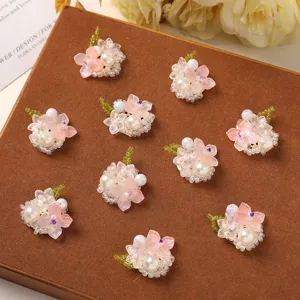 Handmade seed bead flower clusters with pearls and pink petals for DIY hair clips and earrings.