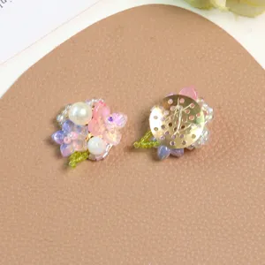 Detailed view of handmade beaded flower cluster charms, fresh spring style accessories.