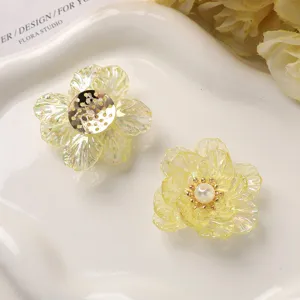 Close-up detail of AB color acrylic flower petals and pearl DIY hair accessory parts.